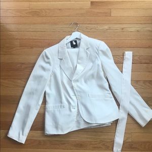 White pant suit with strap.